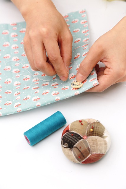 hands matching patterned fabric panels cutting table